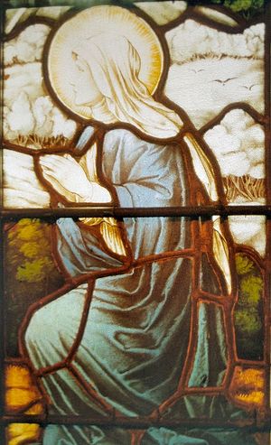 A stained glass image of St. Bega inside one of the Cumbria's parish churches