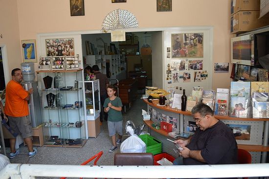 An underground door leads to the front of the thrift shop where voluteers are busy organizing supplies and tending shop