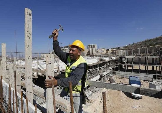 A Palestinian laborer works on a construction site in the new Palestinian town dubbed Rawabi or "The Hills", near the West Bank city of Ramallah. (photo credit:REUTERS)