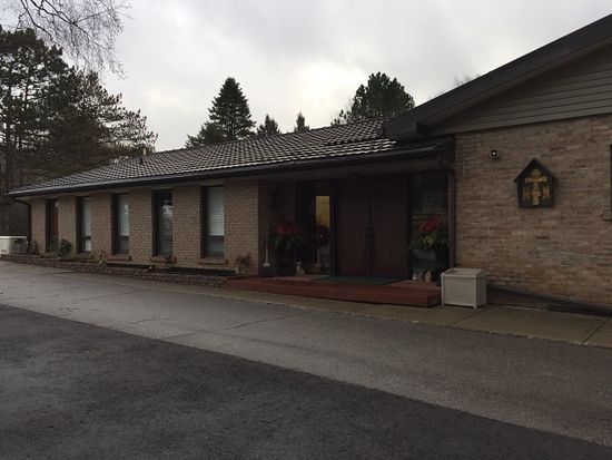 The site includes a main convent building, above, and an adjacent candle-making facility. The nuns also maintain the grounds, cutting trees and grass in summer, plowing paths and roads in winter and tending to natural spring-fed ponds stocked with fish. (Maureen Brosnahan/CBC)