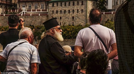 Pilgrims and monks are going to disembark on the shore of Mt. Athos.