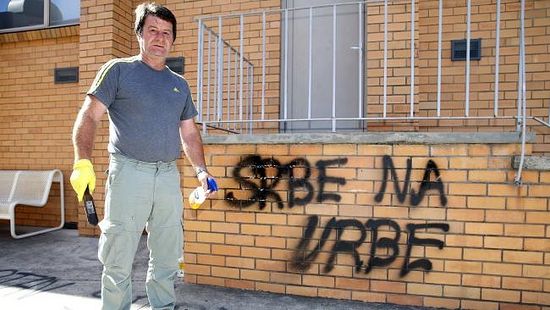 Serbian Orthodox Church was vandalised overnight. President of the Serbian Community and church, Miroslav Perisic cleans the graffiti from the church walls. Picture: Mike Dugdale
