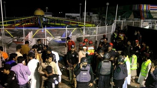 Pakistani police and rescue workers gather at the scene of the attack.