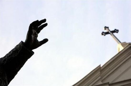 (Reuters/Fatih Saribas)The hand of the statue of Pope Benedict XV is seen under the cross of the St. Esprit Cathedral in Istanbul.
