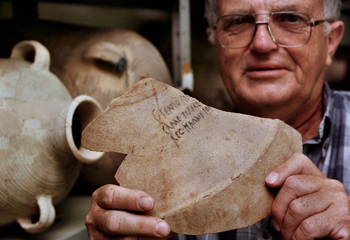 Israeli archaeologist Prof. Ehud Netzer displays the shard from a 2,000-year-old amphora bearing the name of "Herod the Great, King of Judea" July 9. The unique ceramic shard, found during a recent archaeological dig on the ancient desert fortress of Masada, came from a large amphora used for shipping Italian wine to the king who ruled the holy land at the time of Jesus' birth. 