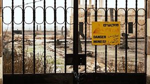 A sealed gate preventing visitors from approaching a church at Qasr al-Yahud, the Jordan River site believed by many Christians to be the site of Jesus’s baptism. A sign on the gate reads “Danger mines!” in Hebrew, Arabic and English. (YouTube screen capture)