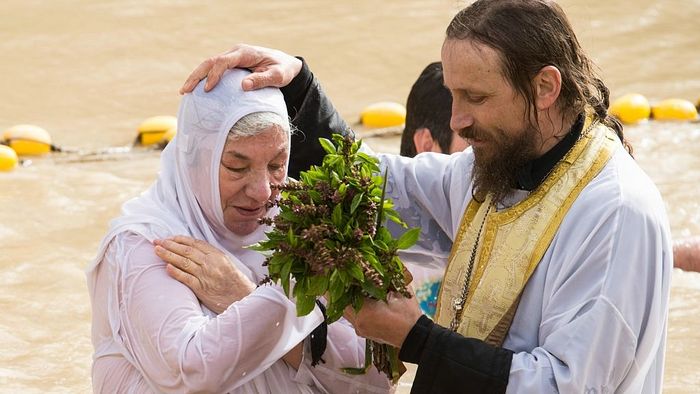 A baptism at the Qasr al-Yahud holy site on the Jordan River, where many Christian denominations believe Jesus was baptized. (HALO Trust)