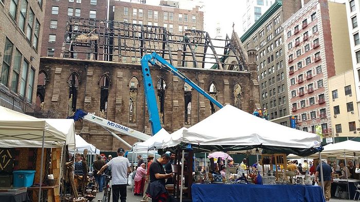 The cathedral on May 14, with the roof beams still in place. The Chelsea Flea Market is in the foreground.