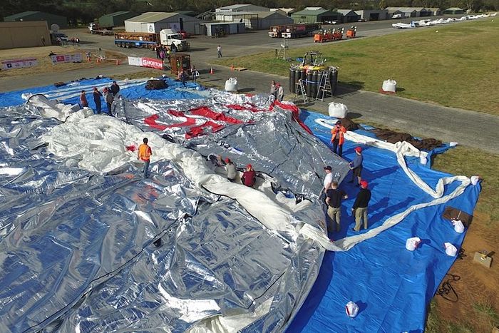 PHOTO: A team of volunteers helps prepare the hot-air balloon. (Supplied: Skyworks WA)