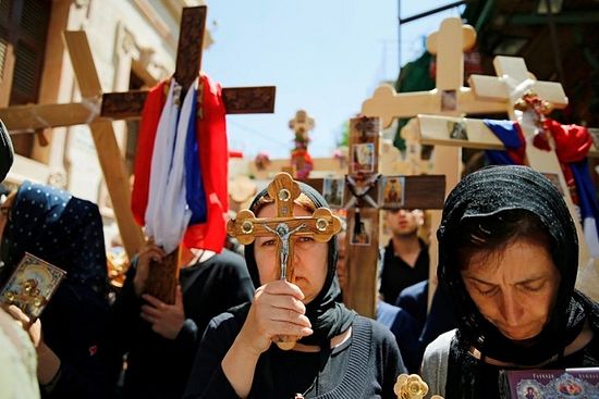 Reuters / Orthodox Christian worshippers hold crosses before a procession along the Via Dolorosa on Good Friday during Holy Week in Jerusalem's Old City.