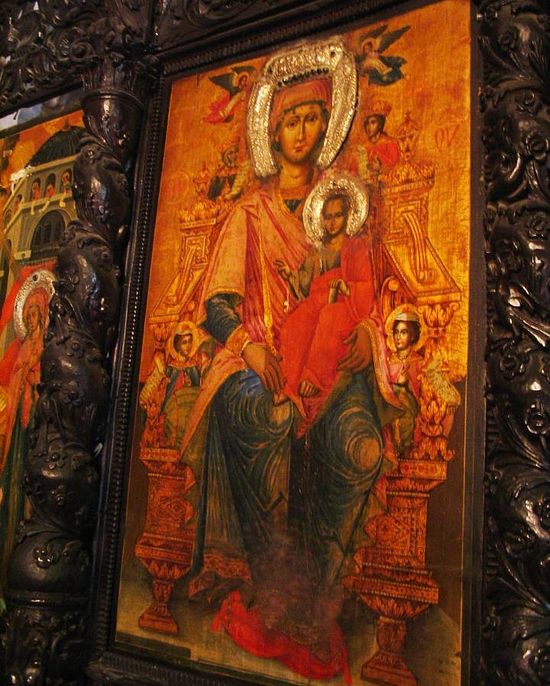 Mary and infant Jesus are one of the paintings decorating the wooden screen.
