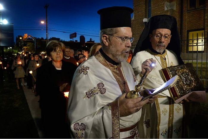 (Scott Sommerdorf | The Salt Lake Tribune) Rev. Matthew Gilbert, left, chants during the Lamentation of the Tomb procession in April 2015 at Holy Trinity Greek Orthodox Cathedral as Father Luke Kontgis holds a flashlight. Members of the Greek Orthodox Church of Greater Salt Lake's Holy Trinity Cathedral and Prophet Elias Church are mourning a diagnosis of late-stage bone cancer for their senior priest, Rev. Gilbert.