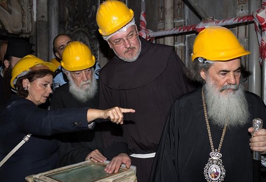 Chief Scientific Supervisor Antonia Moropoulou shows the exposed tomb to (from left) representatives of the Armenian Patriarch Nourhan Manougian and Franciscan Custos Fr. Francesco Patton, and Thephilos III, the Greek Patriarch of Jerusalem. PHOTOGRAPH BY ELISAVET TSILIMANTOU, JERUSALEM PATRIARCHATE - NATIONAL TECHNICAL UNIVERSITY OF ATHENS
