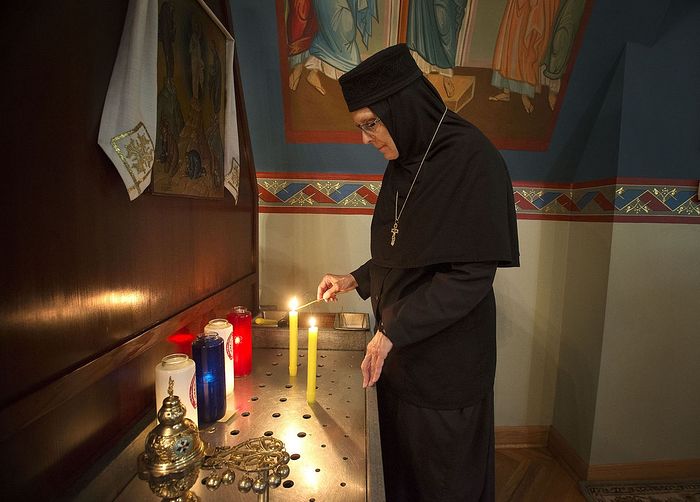 Abbess Mother Christophora Matychak lights candles Thursday in the Transfiguration chapel at the Orthodox Monastery of the Transfiguration in Wayne Township. The monastery turned 50 years old on Friday. Photo: Sally Maxon/GateHouse Media