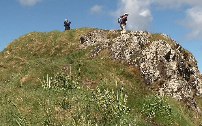Archaeologists on top of a mound where they uncovered conclusive evidence that a wooden hut traditionally associated with St. Columba at his ancient monastery on the island of Iona dates to his lifetime in the late sixth century CREDIT: PA