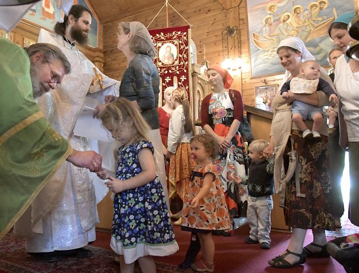Nathan Williams, second from left, is greeted Sunday by his mother, Cindy, after his elevation to the priesthood in the Russian Orthodox Church during services at the Saint Alexander Nevsky Church in Richmond. Staff photo by Andy Molloy